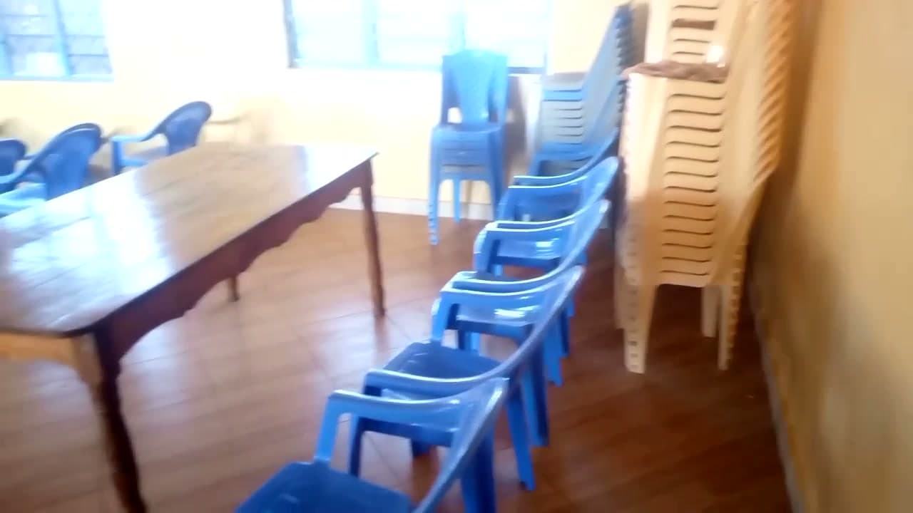 Wooden tables and stacks of chairs