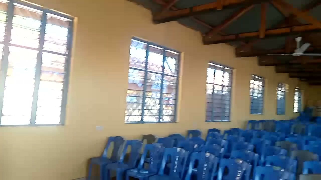 Tall louvred windows along the hall wall
